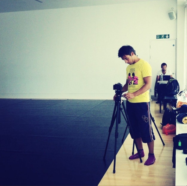 Gab Stifani operating a camera in the rehearsal studio